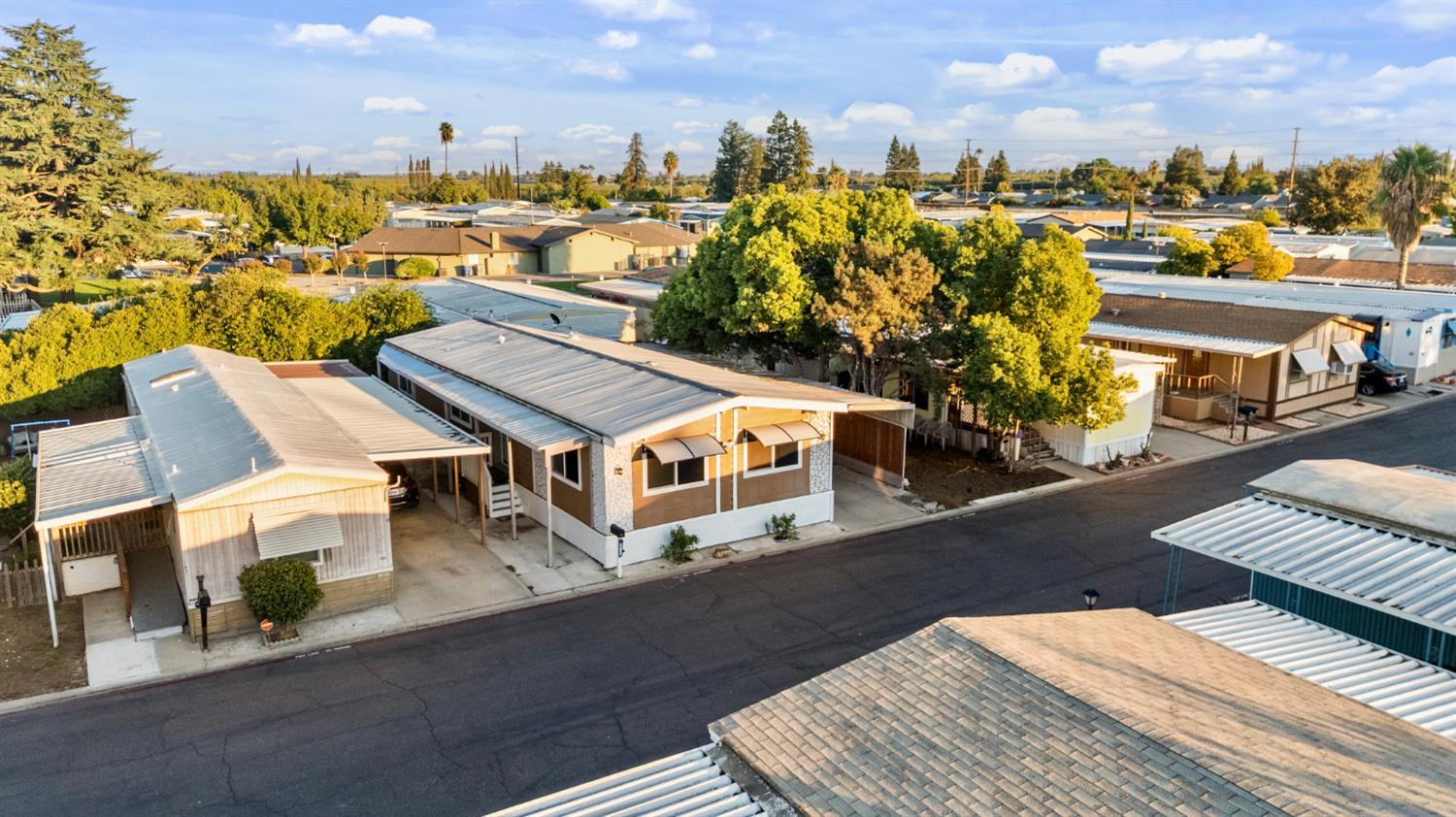 4837 Faith Home Road, Unit 162 Ceres, CA 95307 - Photo 33 of 45 a view of a rooftop deck with couch and trees