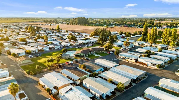 an aerial view of residential building and lake