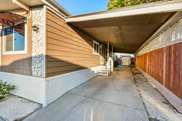 a view of a hallway view with wooden floor and a livingroom view