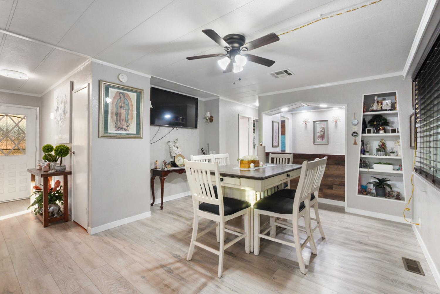 4837 Faith Home Road, Unit 162 Ceres, CA 95307 - Photo 8 of 45 a view of a dining room with furniture and wooden floor