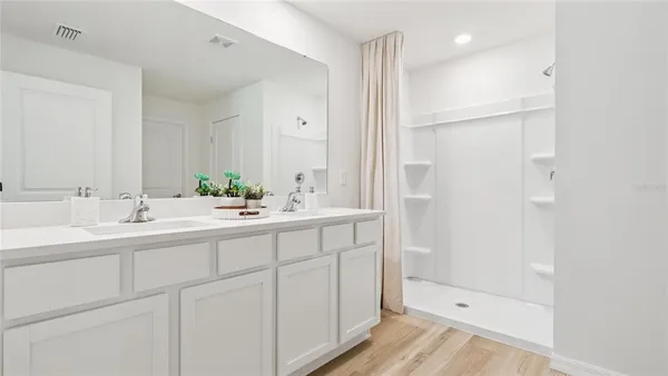 a bathroom with a shower sink and mirror