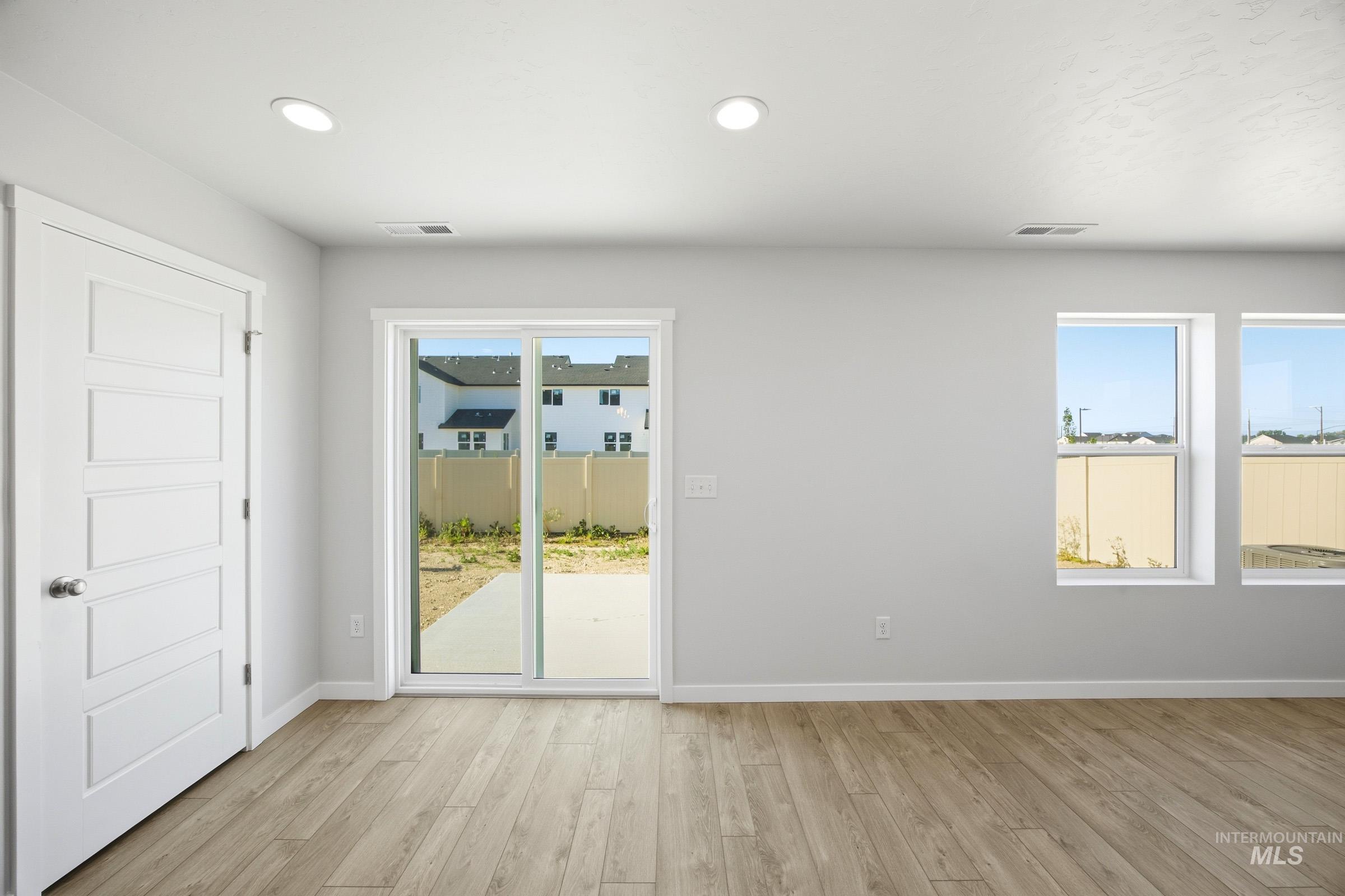 16211 Andes Avenue Caldwell, ID 83607 - Photo 7 of 22 Wood-finish flooring, recessed lighting, and a sliding glass door to the patio