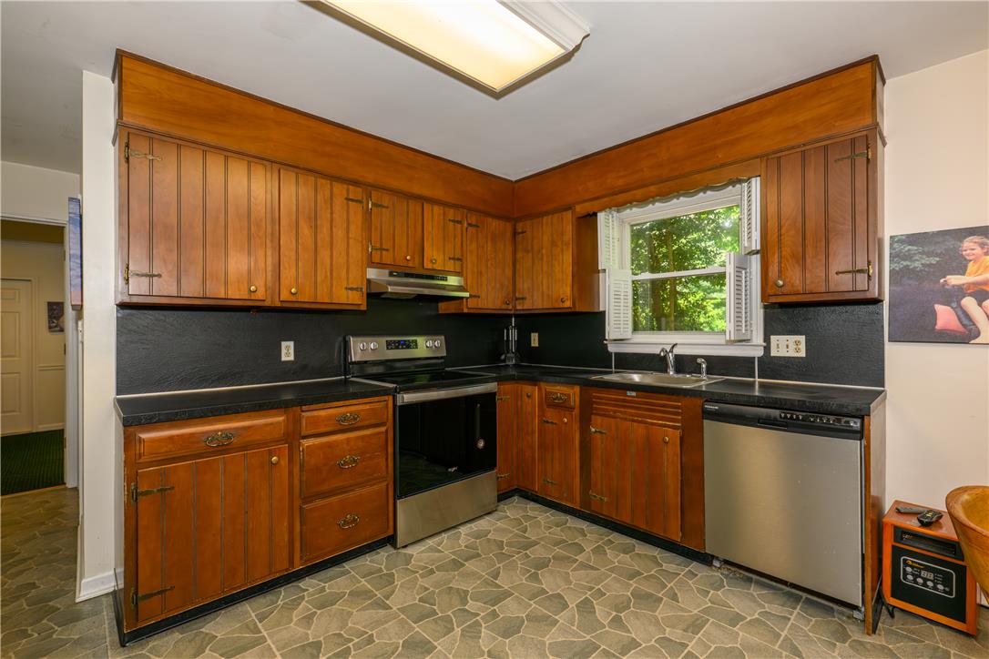 2516 Rachael Lane Orefield, PA 18069 - Photo 4 of 45 A classic kitchen with wooden cabinetry offers ample storage and a cheerful window view.