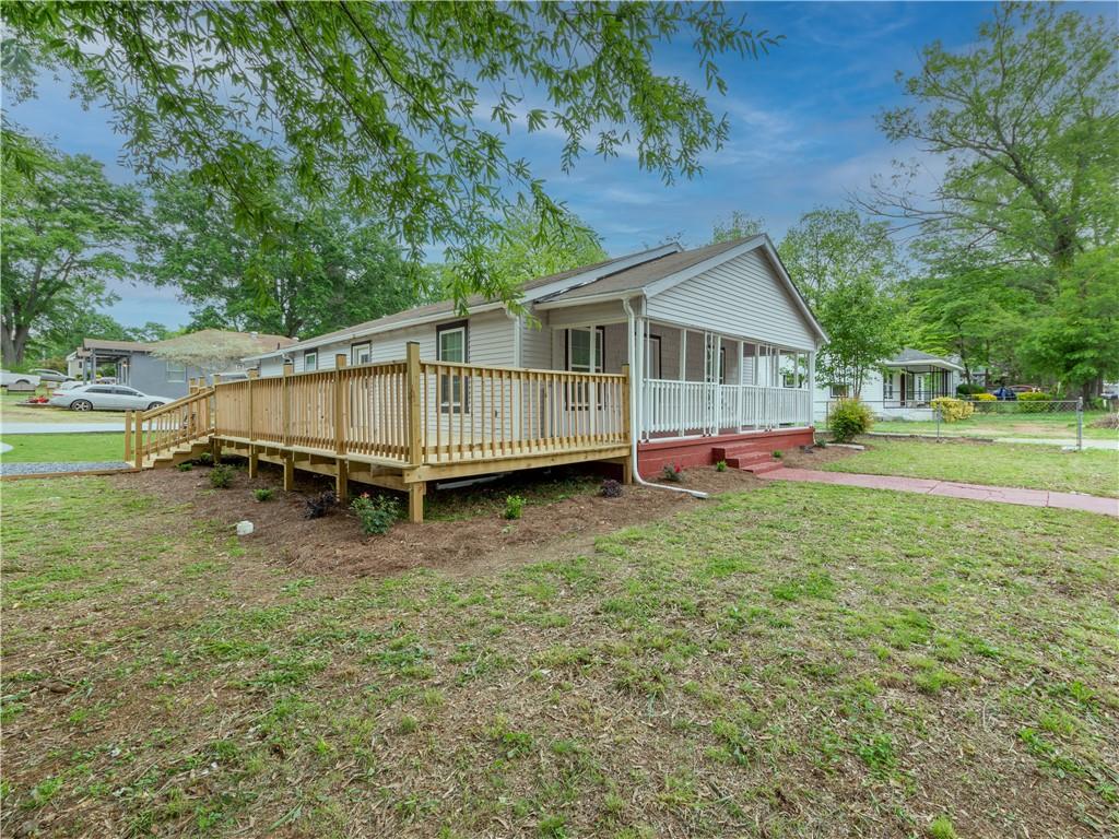 415 East 20th Street Southwest Rome, GA 30161 - Photo 1 of 1 a view of a house with a backyard and a tree