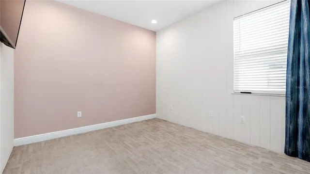 an empty room with windows and closet