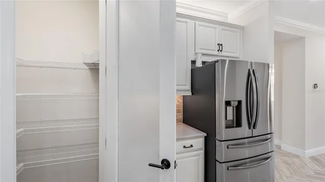 a kitchen with stainless steel appliances granite countertop a stove a sink a microwave a dining table and chairs