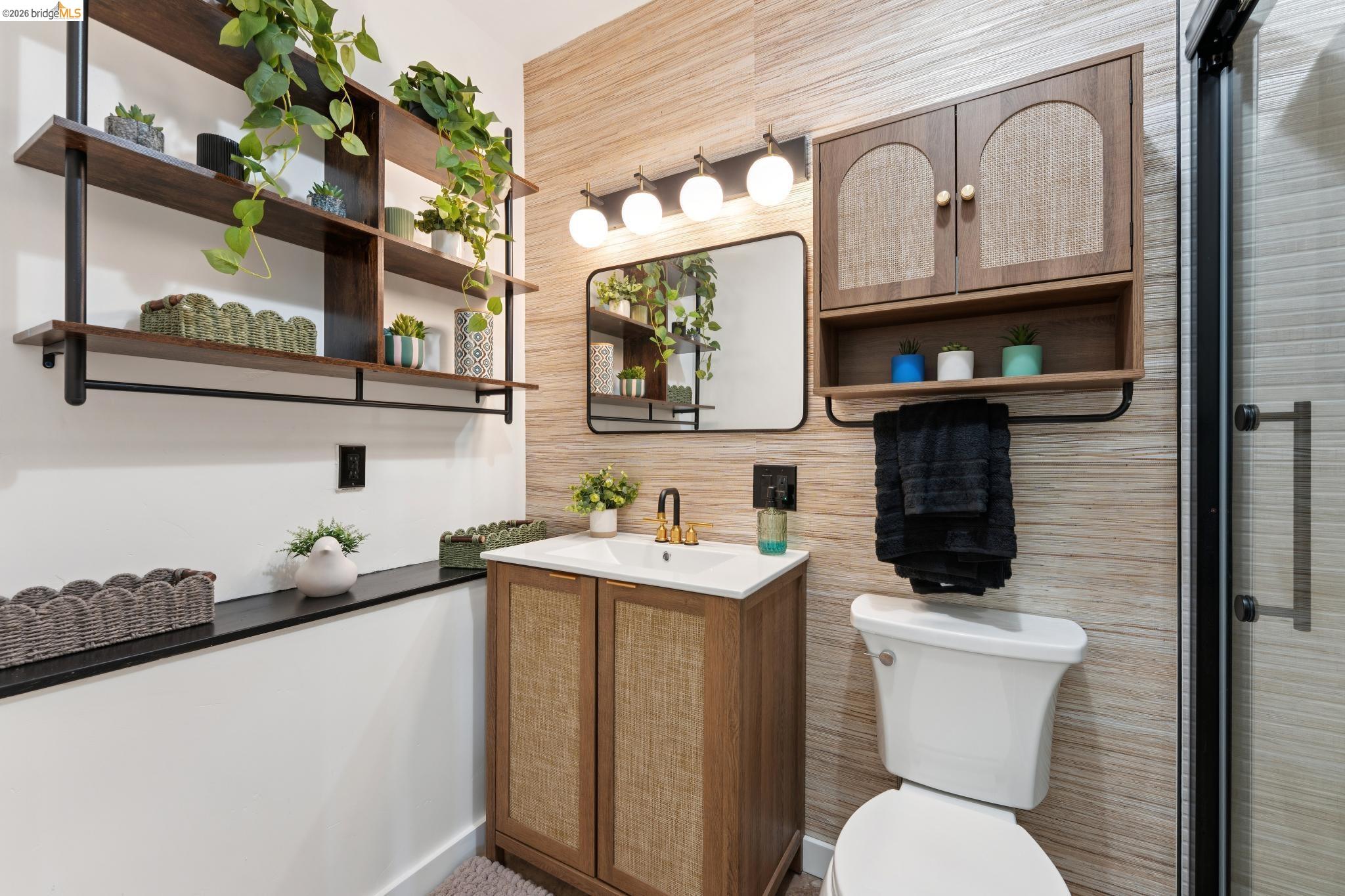 2301 Oak Street Berkeley, CA 94708 - Photo 57 of 61 Bathroom featuring a vanity with a white countertop and gold-finish faucet, a rectangular mirror, and a three-light fixture