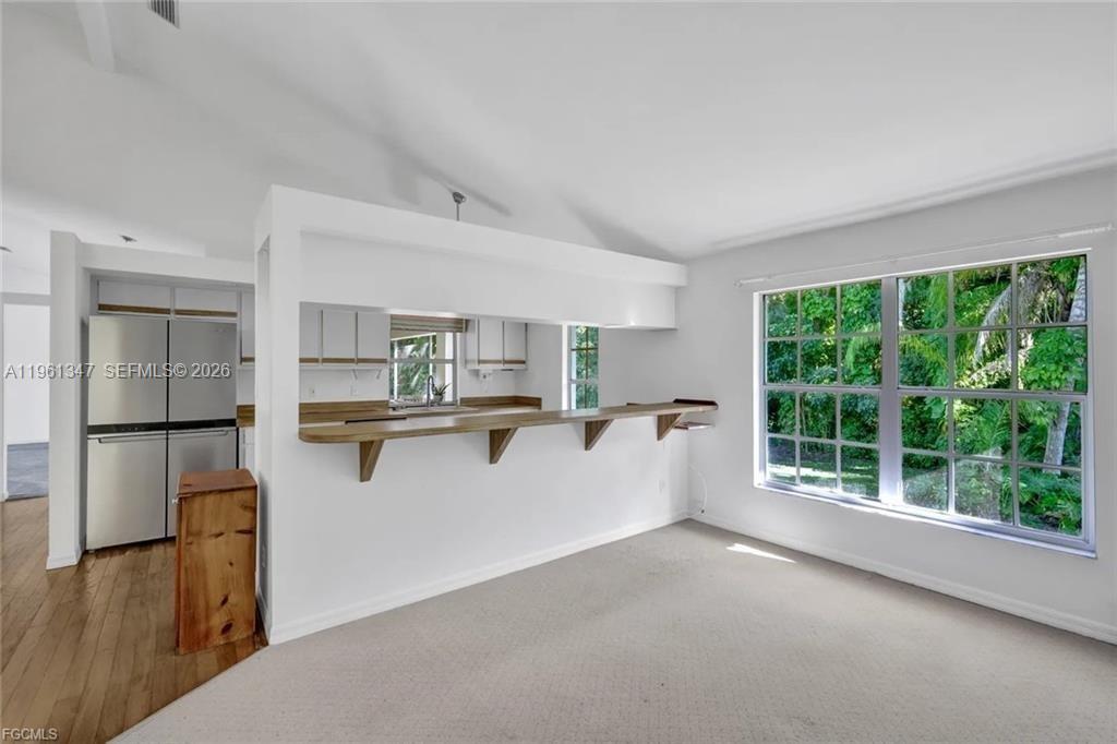 1345 Barrett Road North Fort Myers, FL 33903 - Photo 12 of 27 a kitchen with kitchen island a large counter top space a sink stainless steel appliances and cabinets