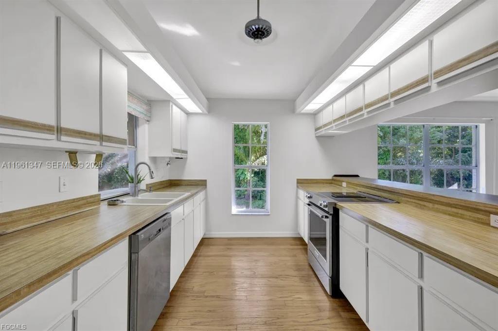 1345 Barrett Road North Fort Myers, FL 33903 - Photo 14 of 27 a kitchen with a sink stove and cabinets