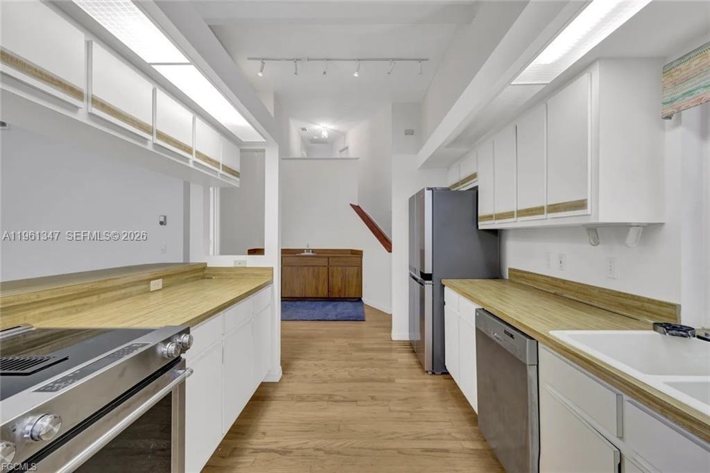 1345 Barrett Road North Fort Myers, FL 33903 - Photo 15 of 27 a view of a kitchen with wooden floor and stainless steel appliances