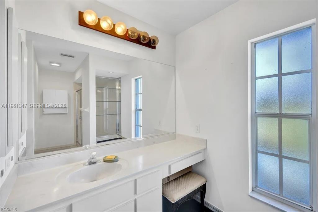 1345 Barrett Road North Fort Myers, FL 33903 - Photo 23 of 27 a bathroom with a sink and a mirror