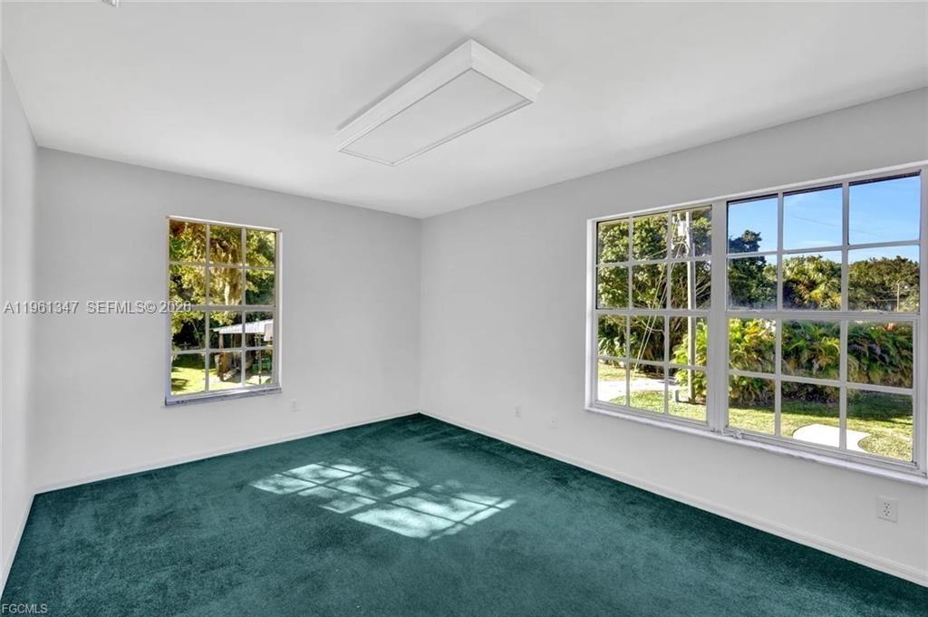 1345 Barrett Road North Fort Myers, FL 33903 - Photo 26 of 27 wooden floor in an empty room with a window