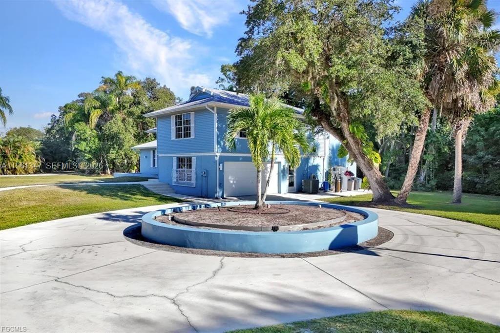 1345 Barrett Road North Fort Myers, FL 33903 - Photo 10 of 27 a view of a house with backyard and tree