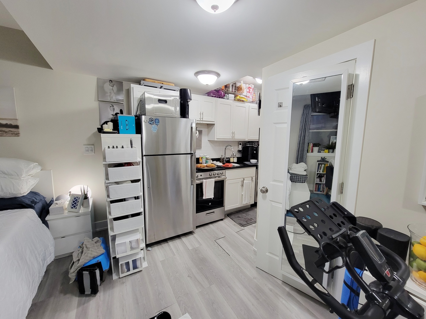 648 West Roscoe Street, Unit NGD Chicago, IL 60657 - Photo 3 of 5 a kitchen with granite countertop a refrigerator stove and wooden floor