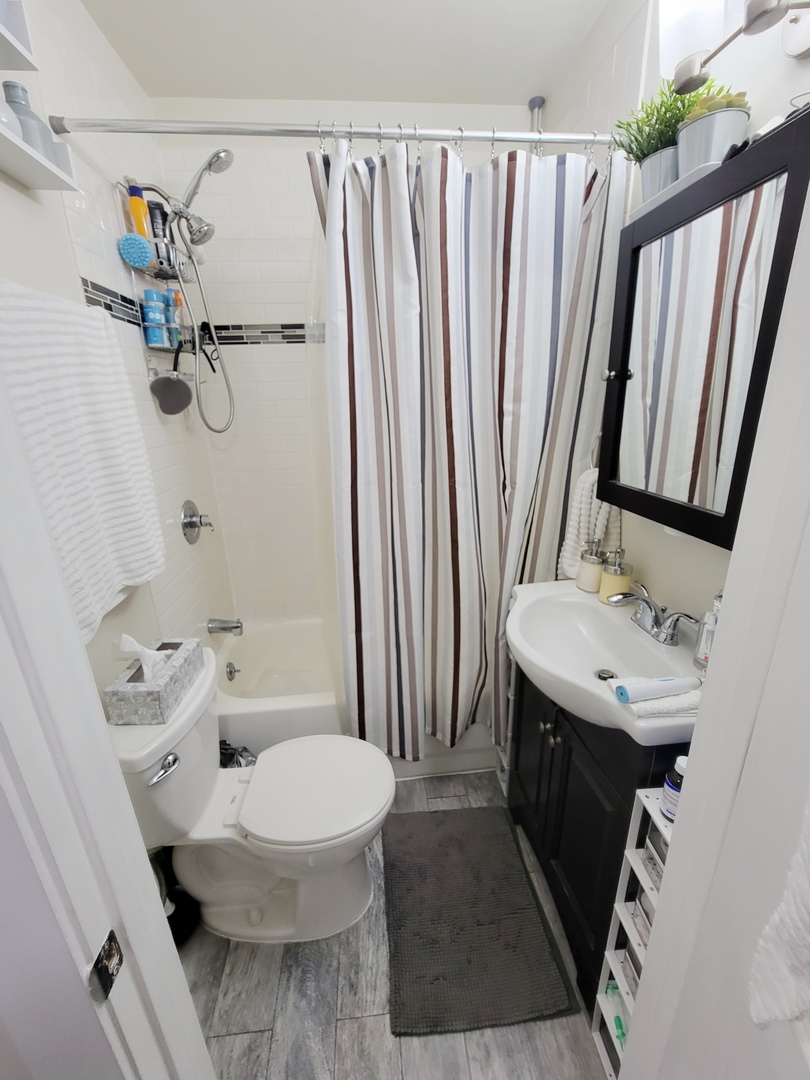 648 West Roscoe Street, Unit NGD Chicago, IL 60657 - Photo 5 of 5 a bathroom with a sink toilet and shower