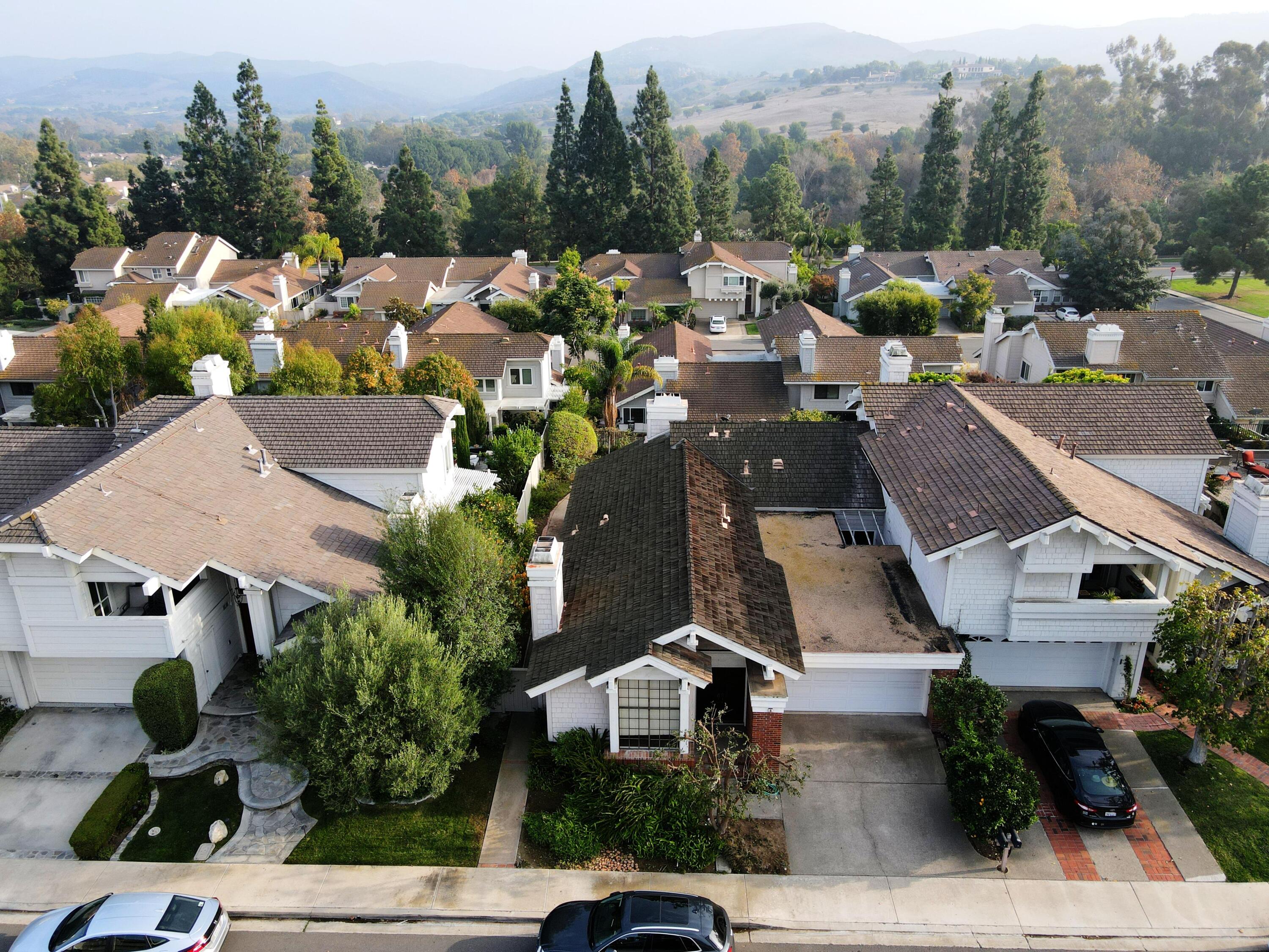 an aerial view of multiple houses with yard