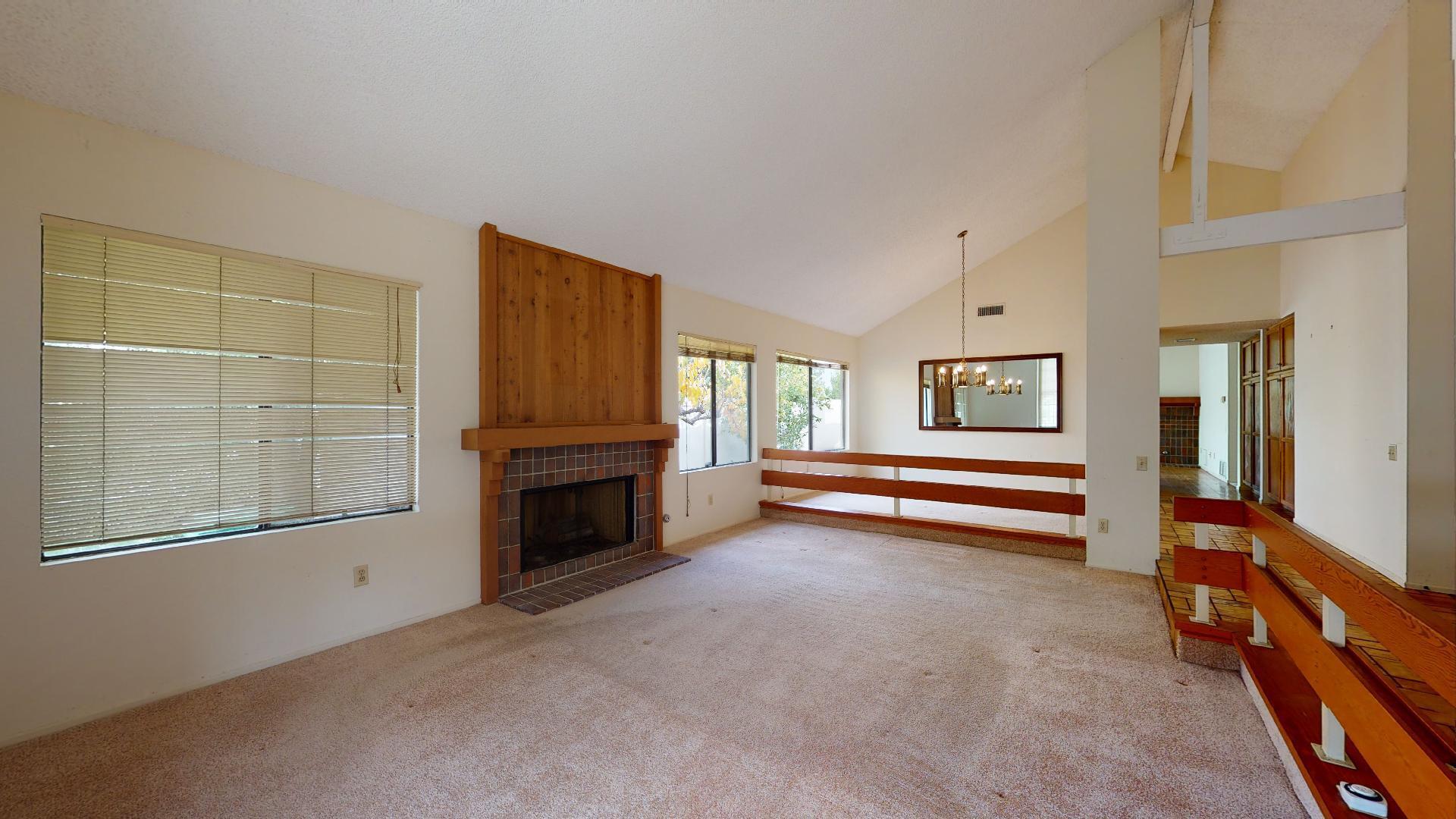8 Elderberry Irvine, CA 92603 - Photo 14 of 59 a view of an empty room with a fireplace and a window