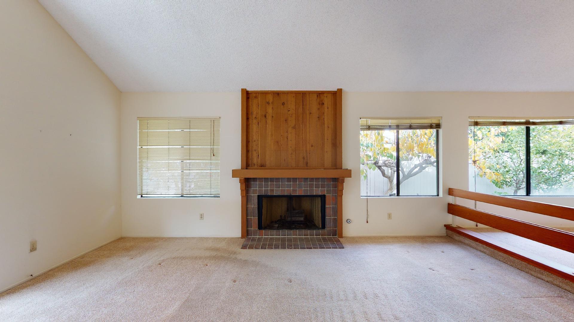 8 Elderberry Irvine, CA 92603 - Photo 16 of 59 an empty room with furniture and a fireplace