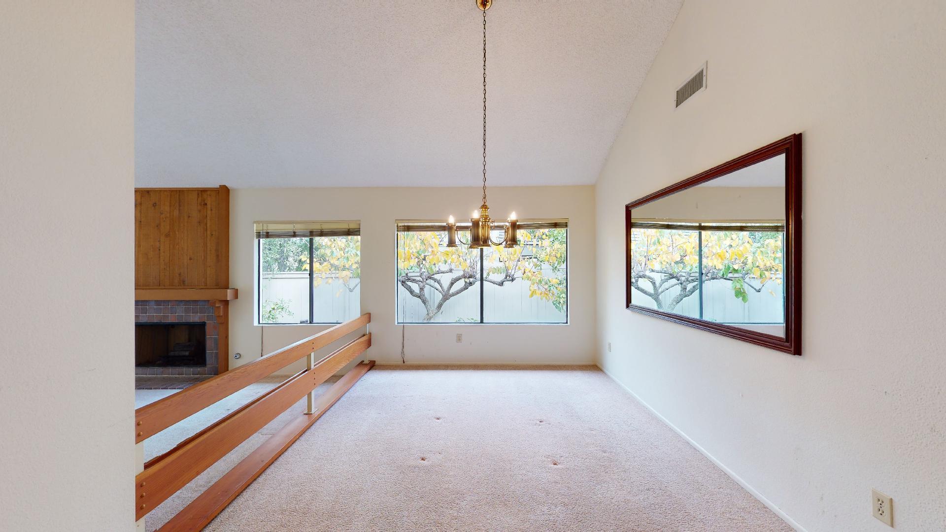 8 Elderberry Irvine, CA 92603 - Photo 18 of 59 a view of an empty room with a fireplace and windows