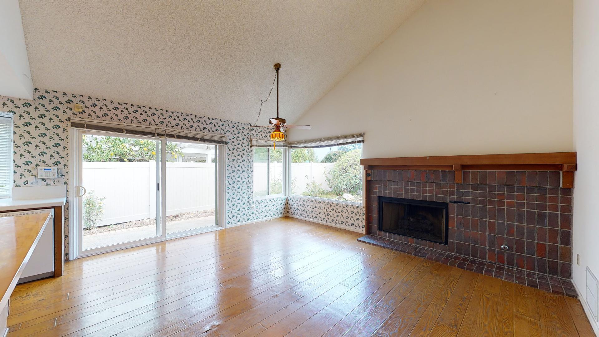 8 Elderberry Irvine, CA 92603 - Photo 23 of 59 an empty room with wooden floor fireplace and windows
