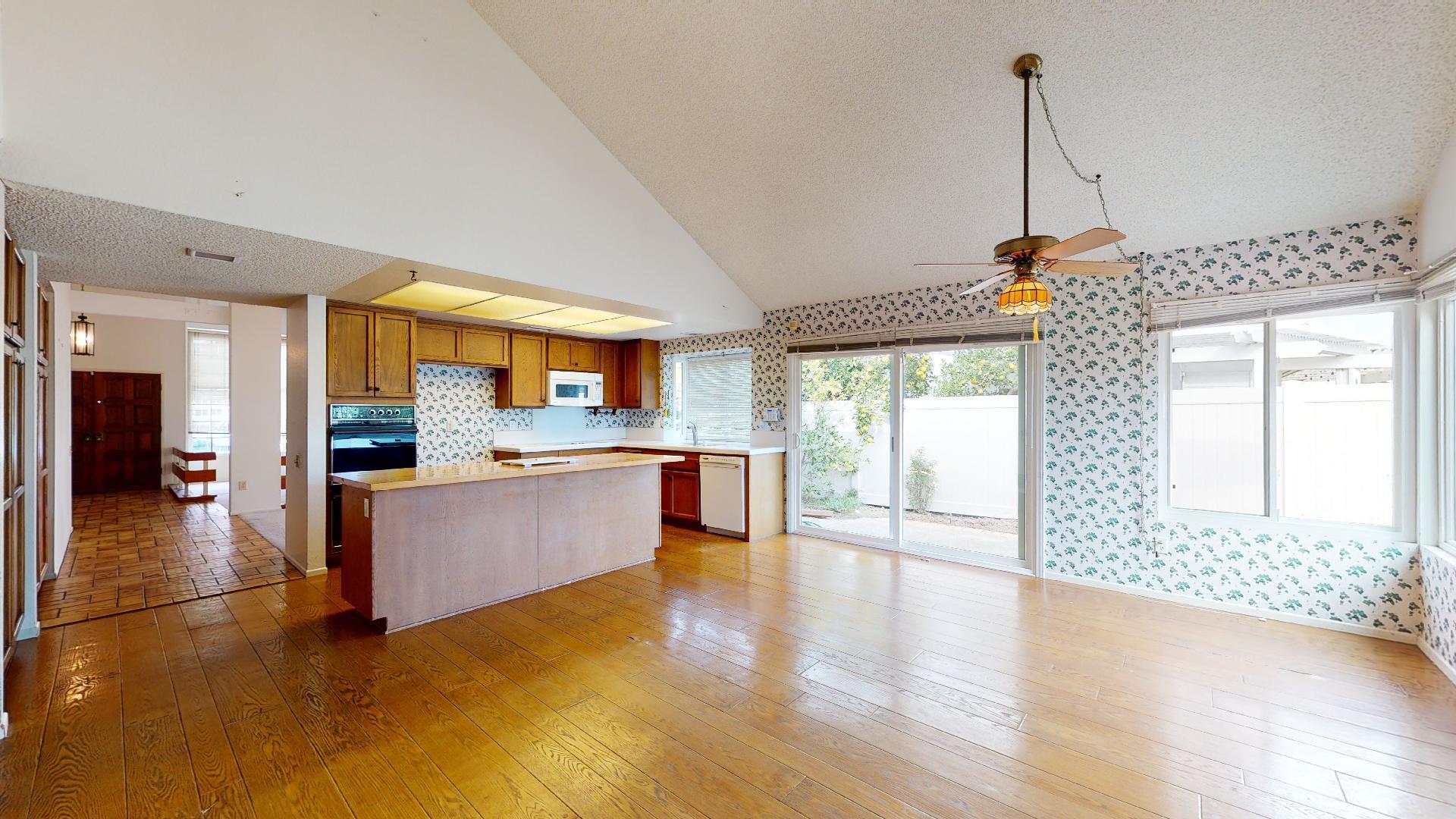 8 Elderberry Irvine, CA 92603 - Photo 24 of 59 a large kitchen with stainless steel appliances granite countertop a stove and a wooden floor