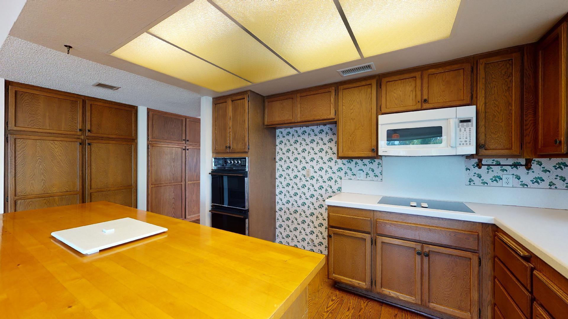 8 Elderberry Irvine, CA 92603 - Photo 29 of 59 a kitchen with stainless steel appliances a sink cabinets and wooden floor