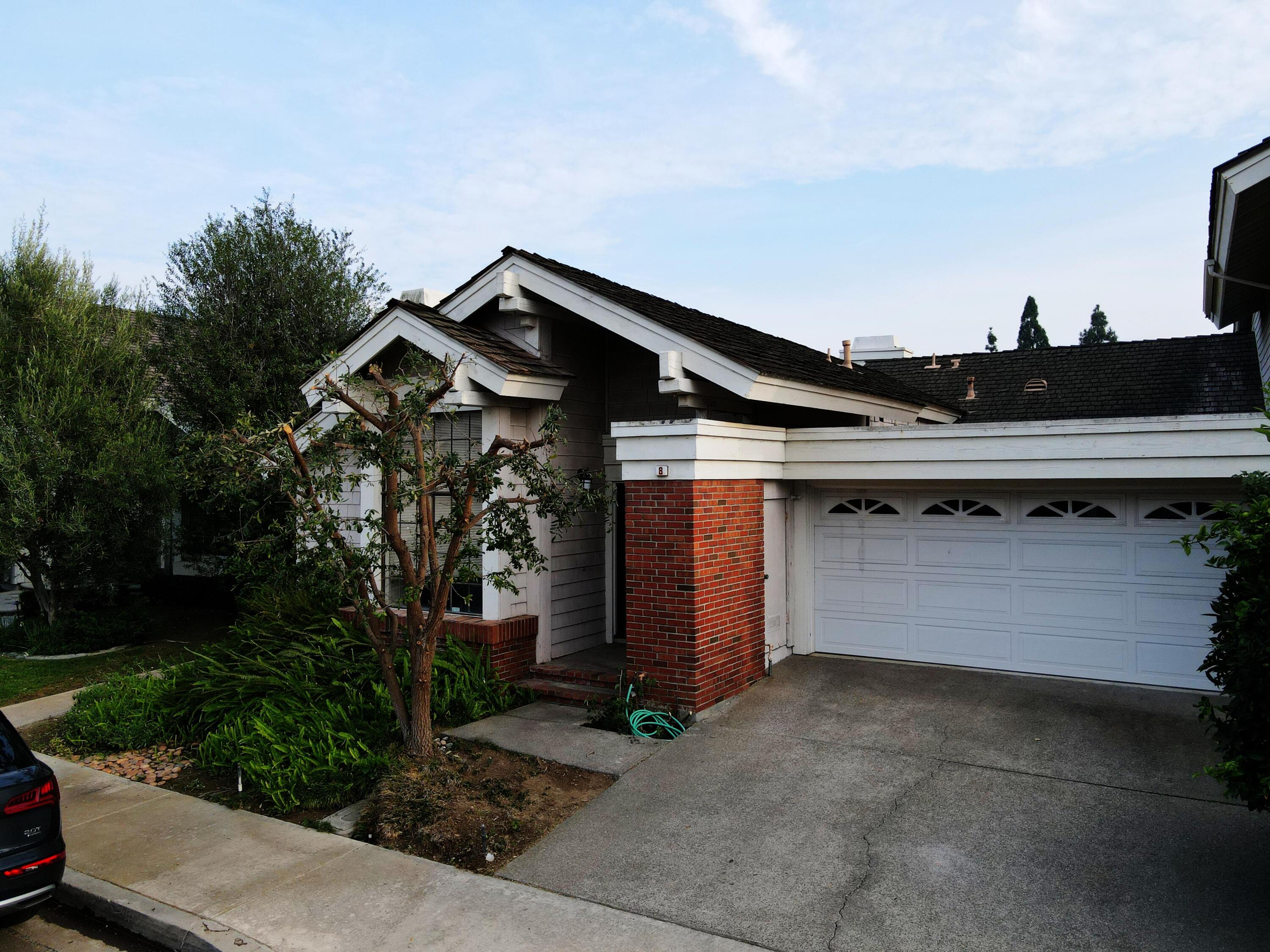 8 Elderberry Irvine, CA 92603 - Photo 3 of 59 a front view of a house with a garage