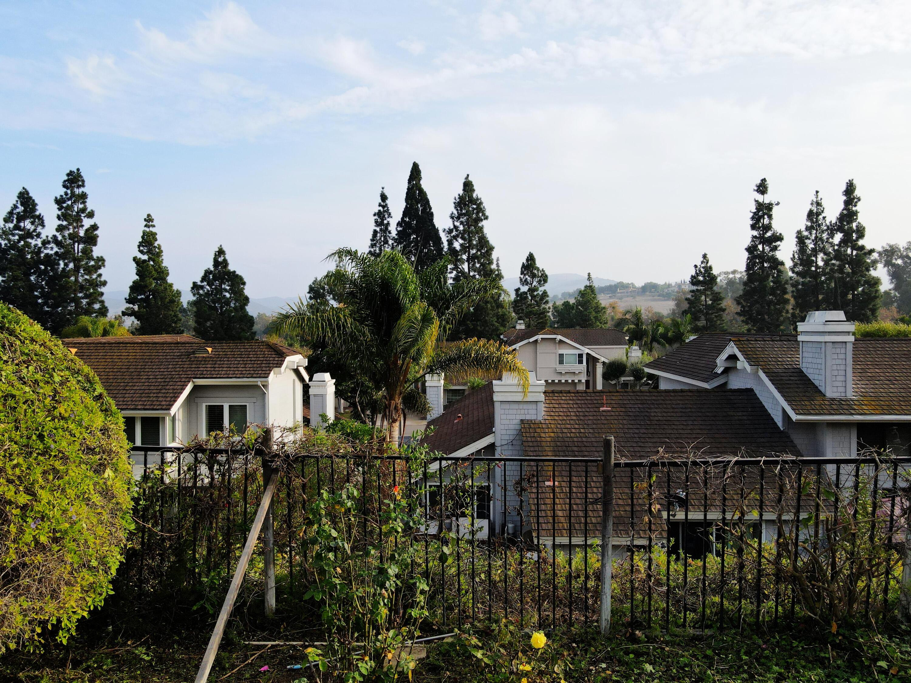 8 Elderberry Irvine, CA 92603 - Photo 7 of 59 a front view of house with yard and mountain in the background