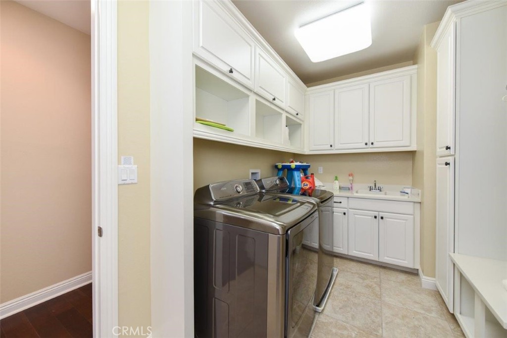 107 Fairgrove Irvine, CA 92618 - Photo 14 of 31 a utility room with cabinets washer and dryer