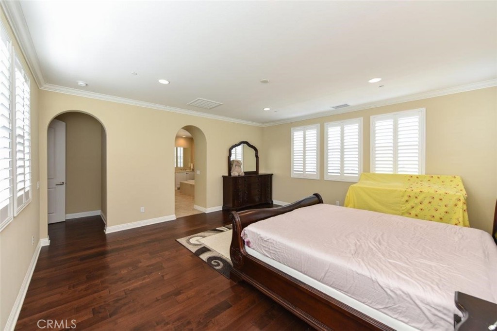 107 Fairgrove Irvine, CA 92618 - Photo 15 of 31 a bedroom with a large bed and wooden floor