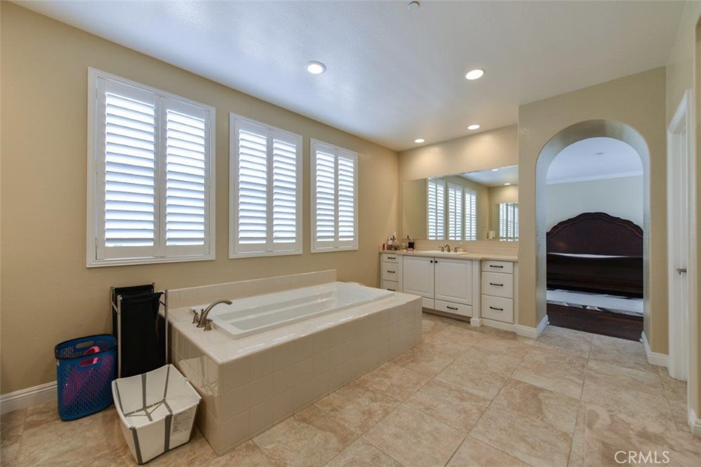 107 Fairgrove Irvine, CA 92618 - Photo 17 of 31 a spacious bedroom with a bed and a large window