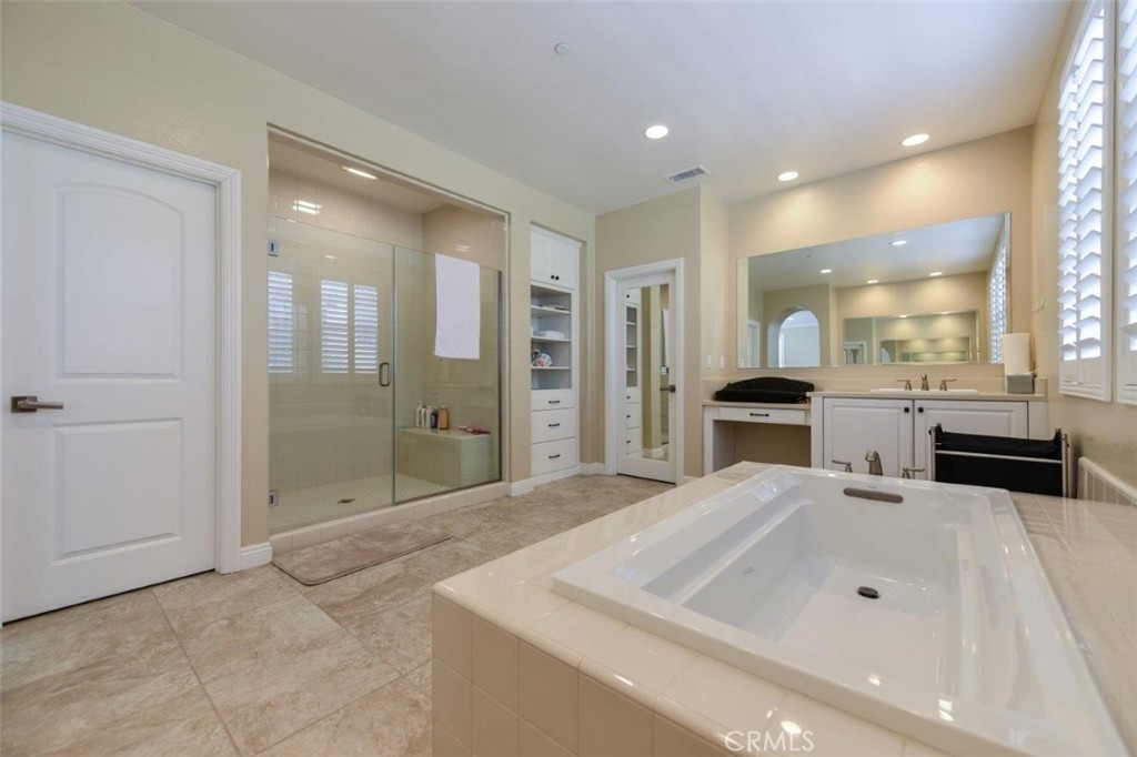 107 Fairgrove Irvine, CA 92618 - Photo 19 of 31 a large bathroom with a sink mirror and shower