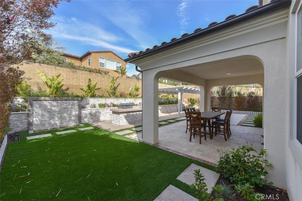 107 Fairgrove Irvine, CA 92618 - Photo 21 of 31 a view of a porch and dining room with furniture and a garden