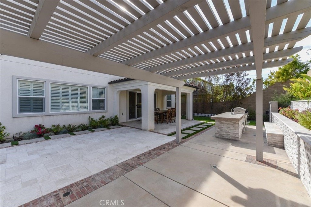 107 Fairgrove Irvine, CA 92618 - Photo 29 of 31 a view of a patio with table and chairs and potted plants