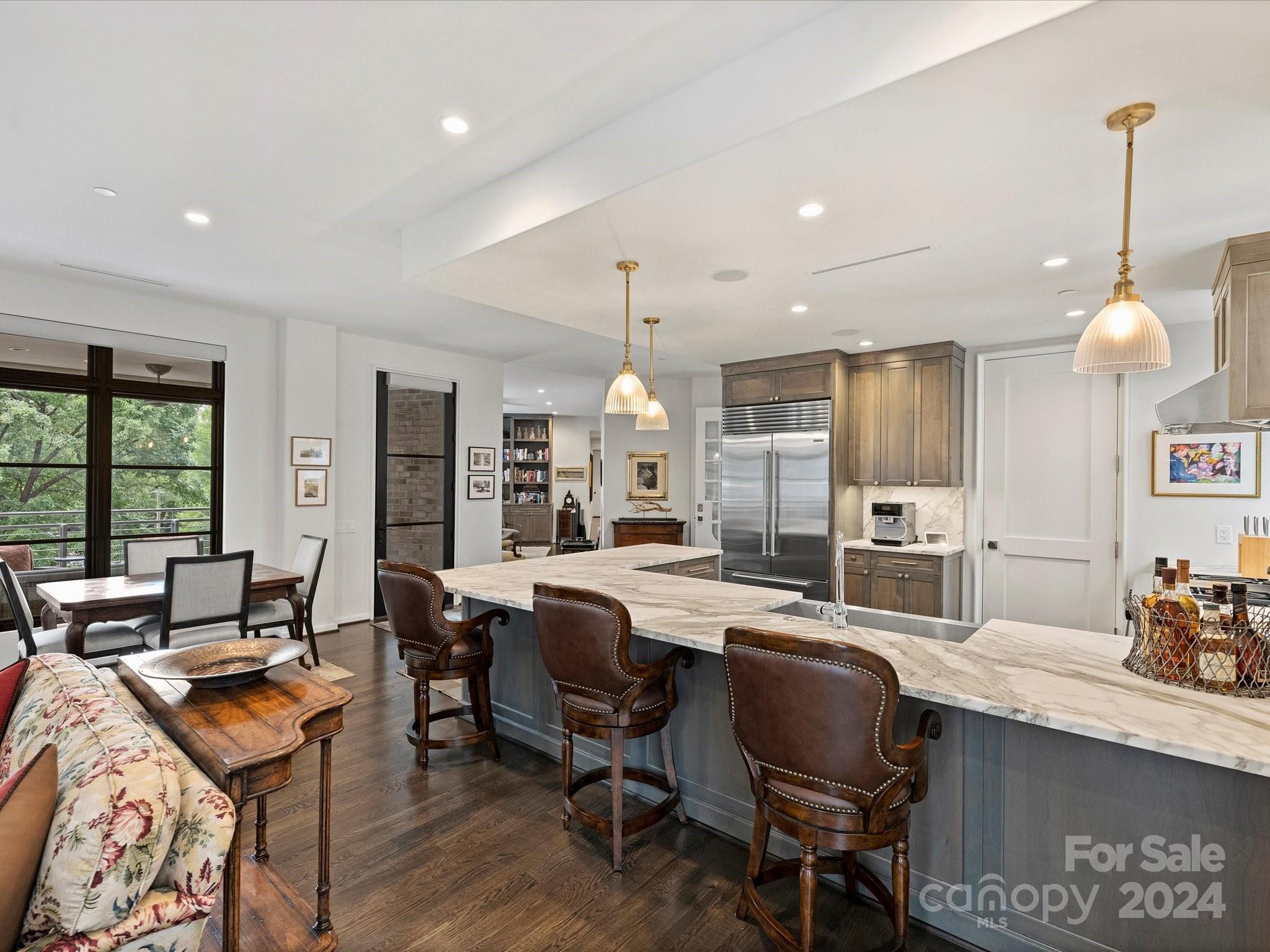1333 Queens Road, Unit E3 Charlotte, NC 28207 - Photo 14 of 42 a large kitchen with a table and chairs