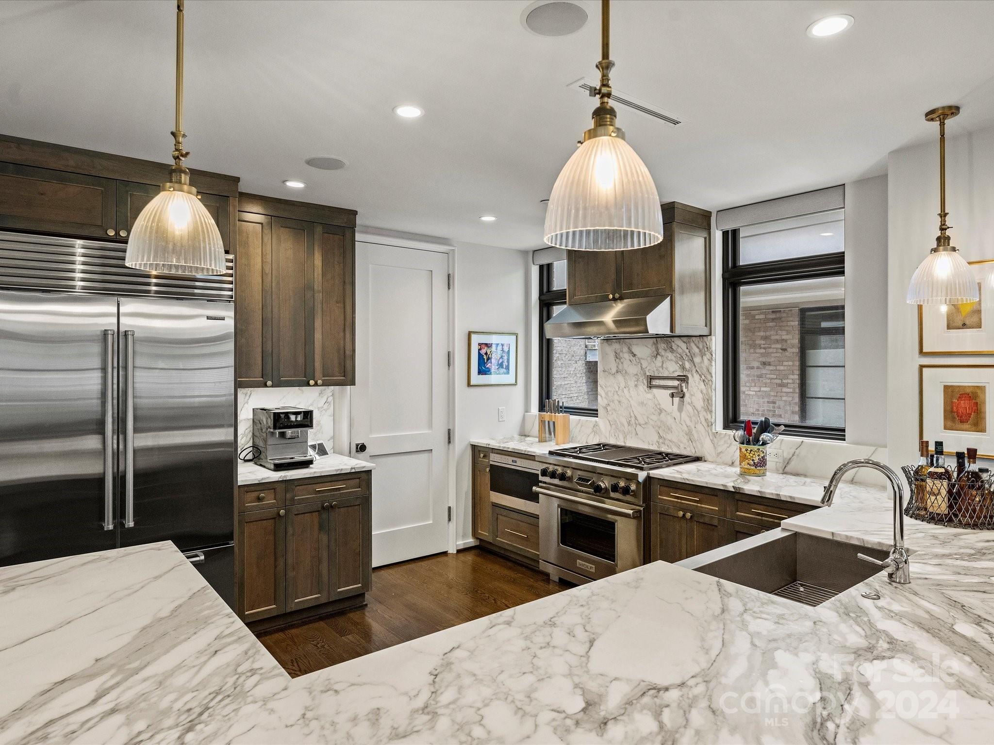 1333 Queens Road, Unit E3 Charlotte, NC 28207 - Photo 15 of 42 a kitchen with stainless steel appliances granite countertop a sink stove and refrigerator