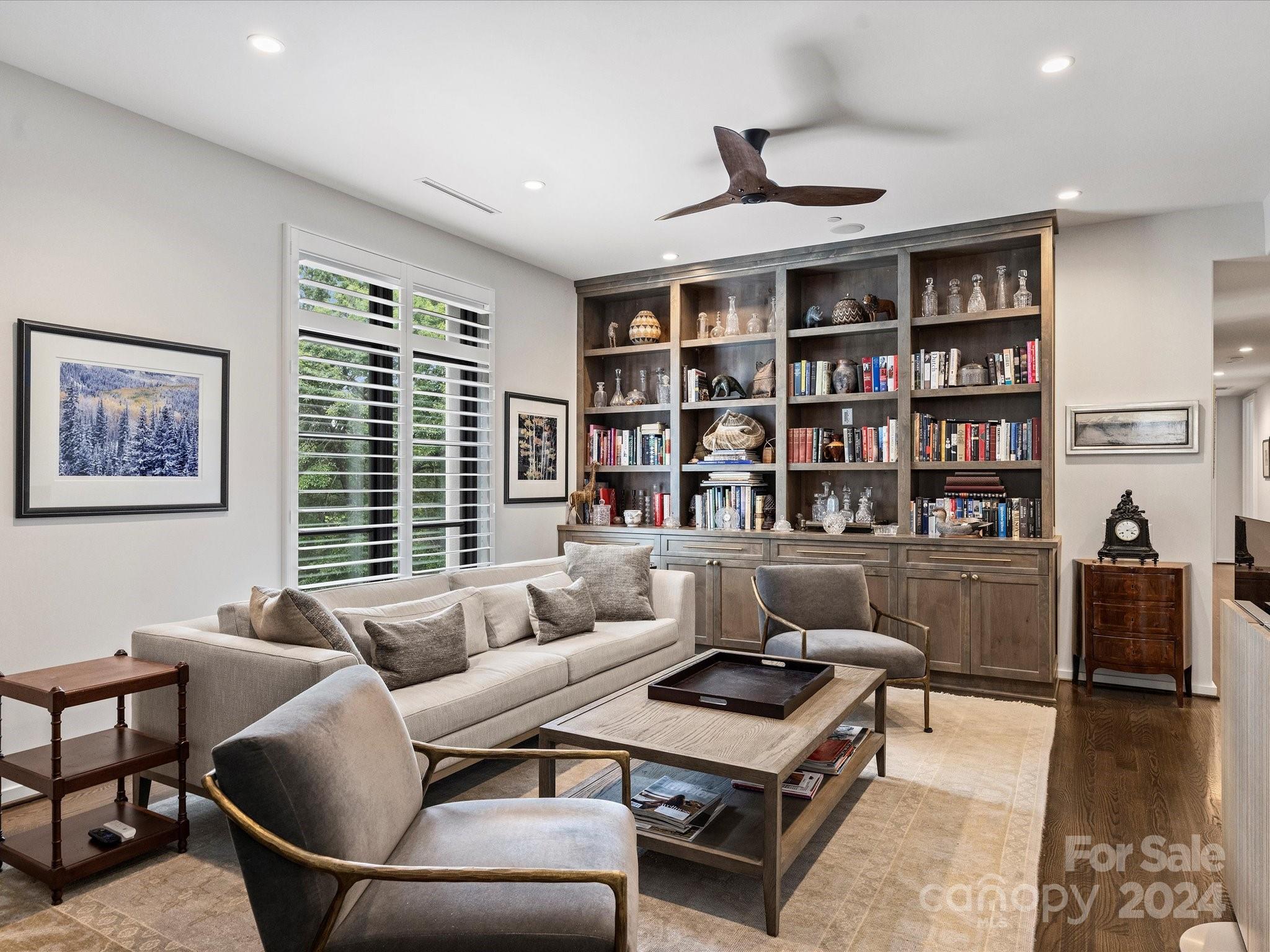1333 Queens Road, Unit E3 Charlotte, NC 28207 - Photo 22 of 42 a living room with furniture and a book shelf