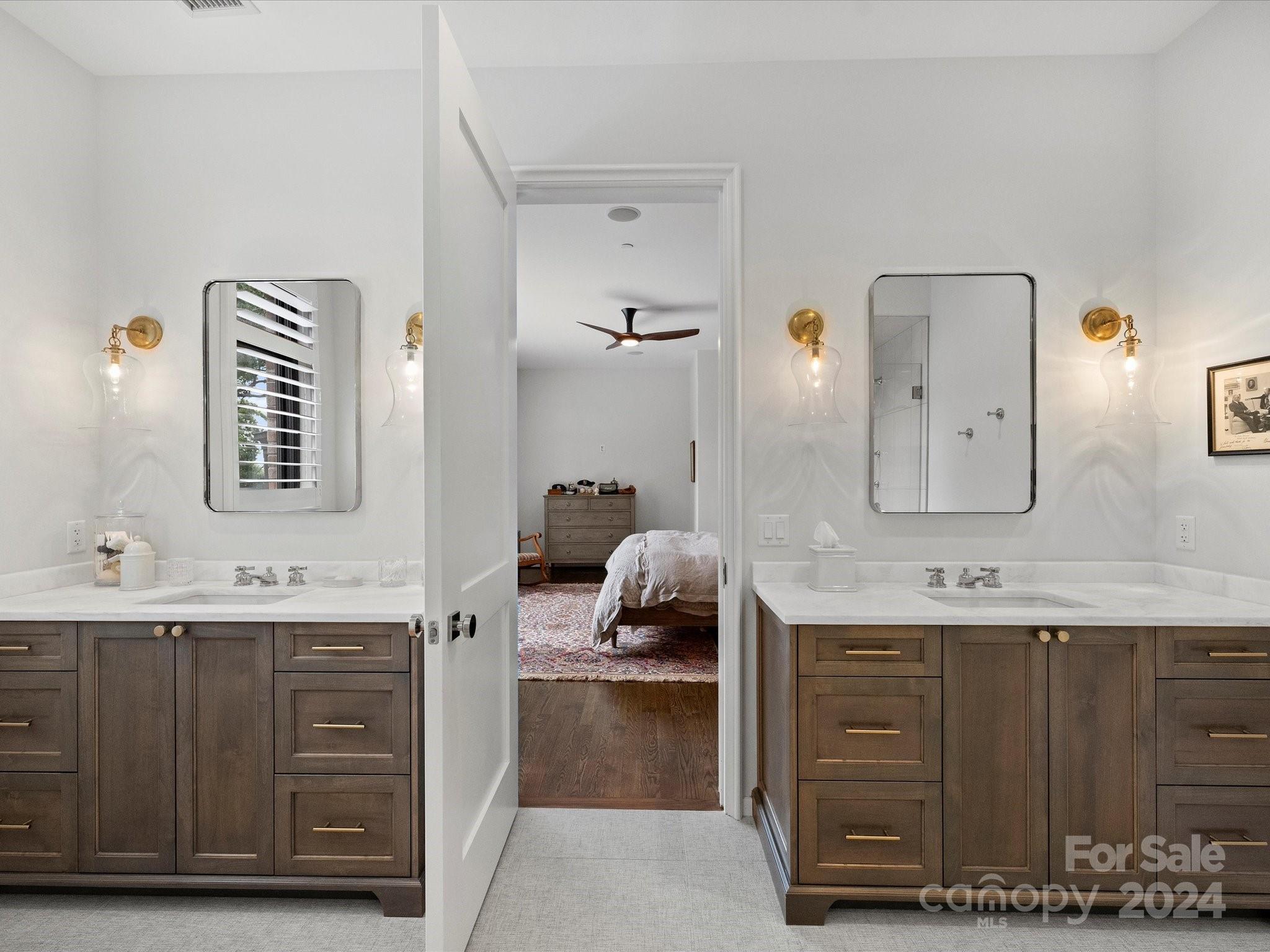 1333 Queens Road, Unit E3 Charlotte, NC 28207 - Photo 28 of 42 a en suite bathroom with a double vanity sink and a mirror