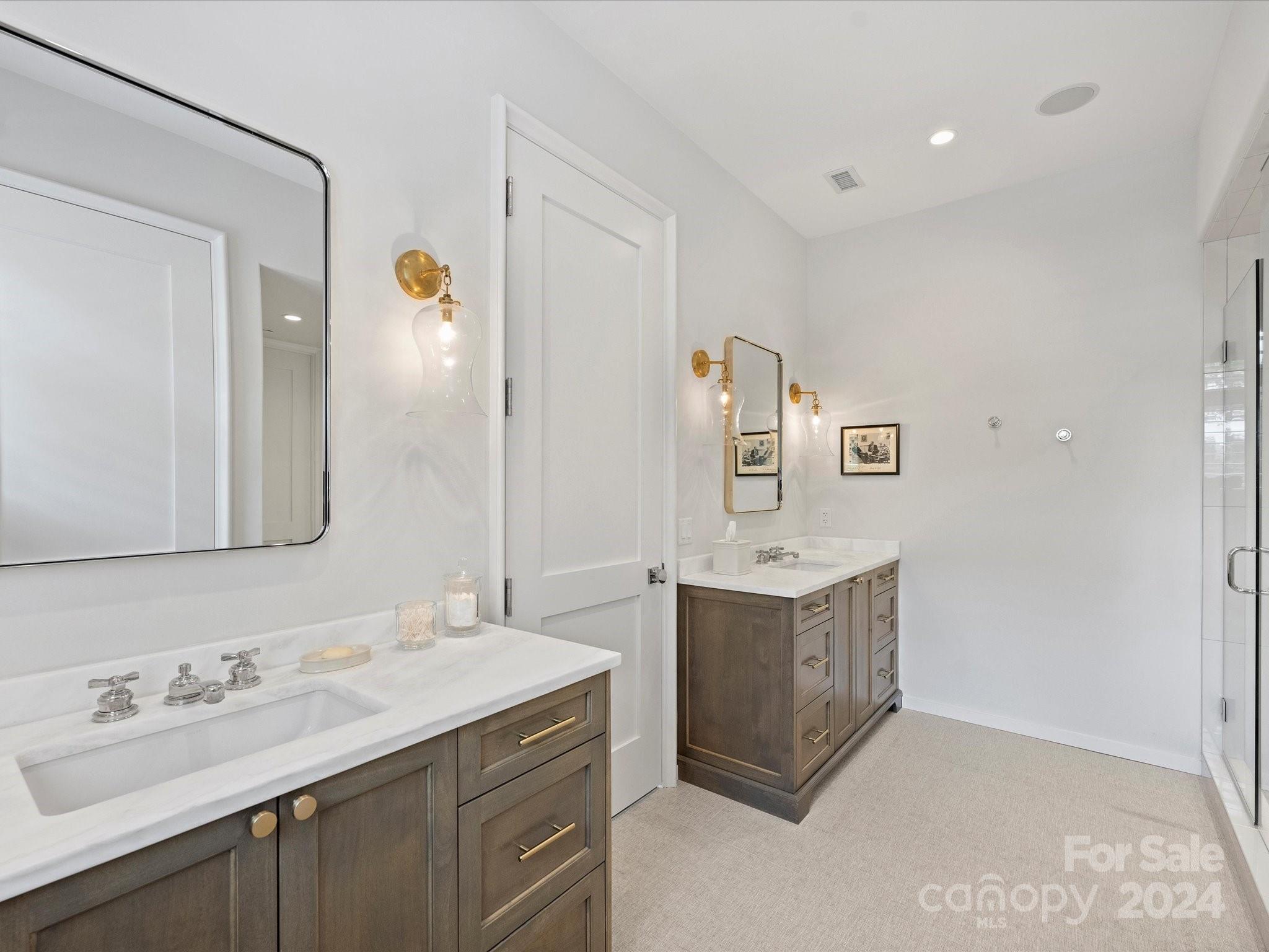 1333 Queens Road, Unit E3 Charlotte, NC 28207 - Photo 30 of 42 a bathroom with a granite countertop double vanity sink mirror and bathtub
