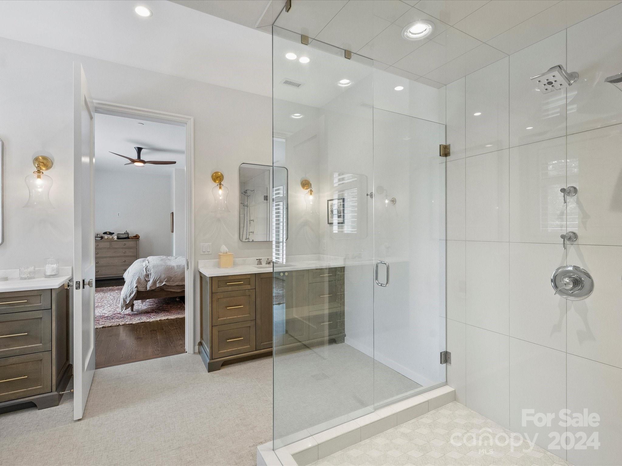 1333 Queens Road, Unit E3 Charlotte, NC 28207 - Photo 31 of 42 a bathroom with a double vanity sink a large mirror and shower