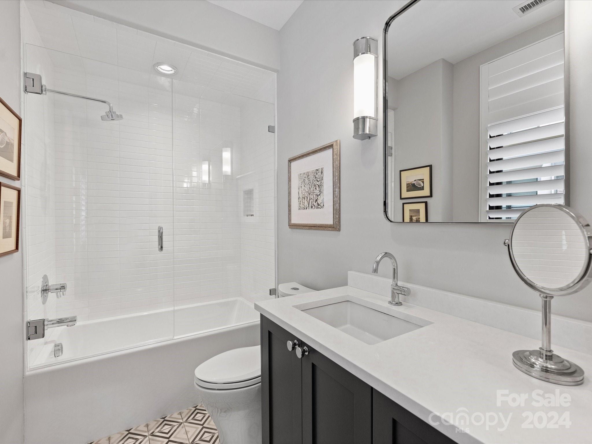 1333 Queens Road, Unit E3 Charlotte, NC 28207 - Photo 35 of 42 a bathroom with a granite countertop sink toilet and shower