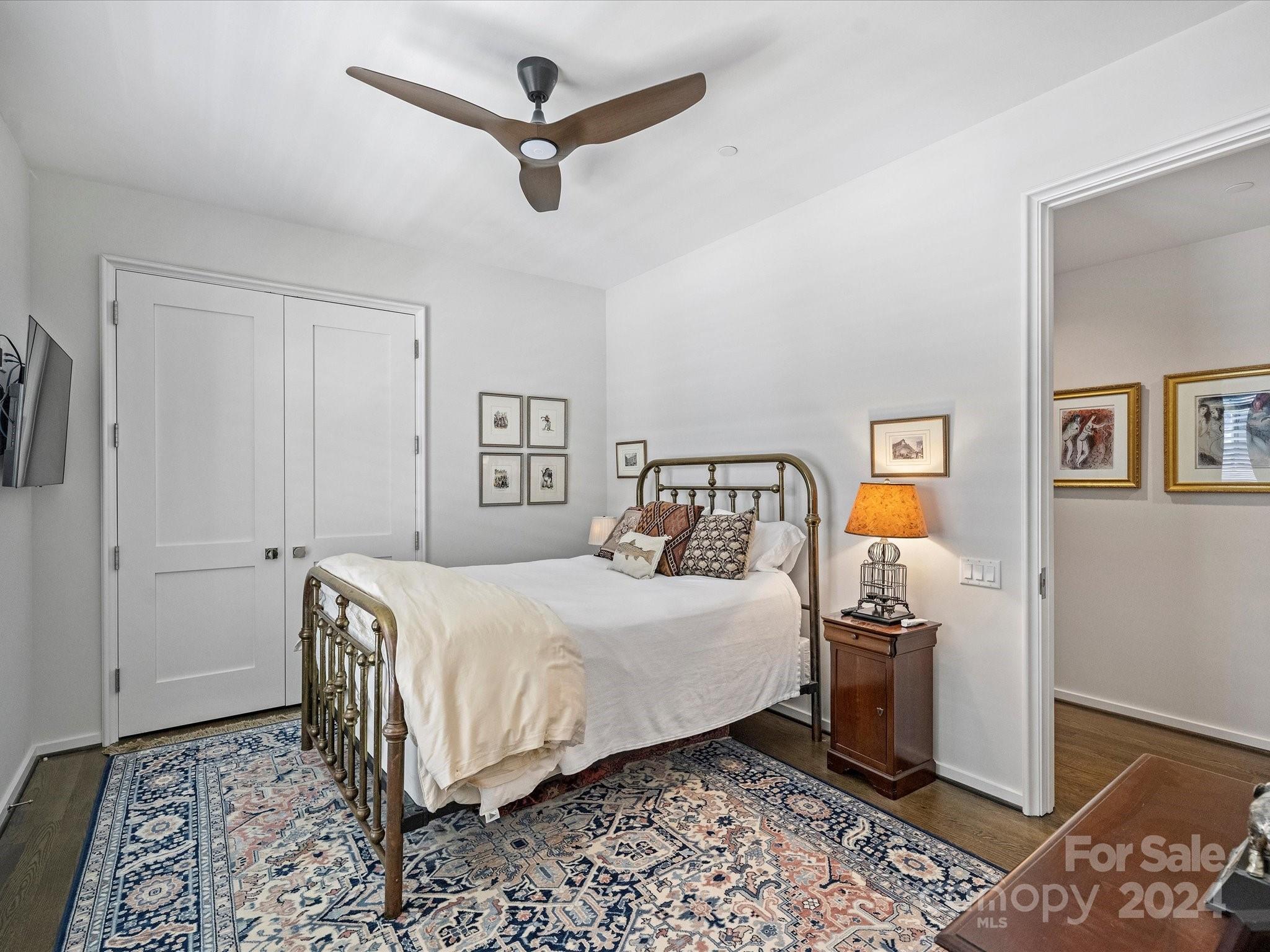 1333 Queens Road, Unit E3 Charlotte, NC 28207 - Photo 36 of 42 a bedroom with a bed and wooden floor