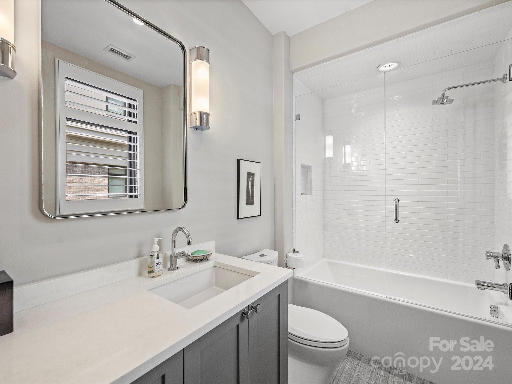 1333 Queens Road, Unit E3 Charlotte, NC 28207 - Photo 38 of 42 a bathroom with a sink a toilet and shower