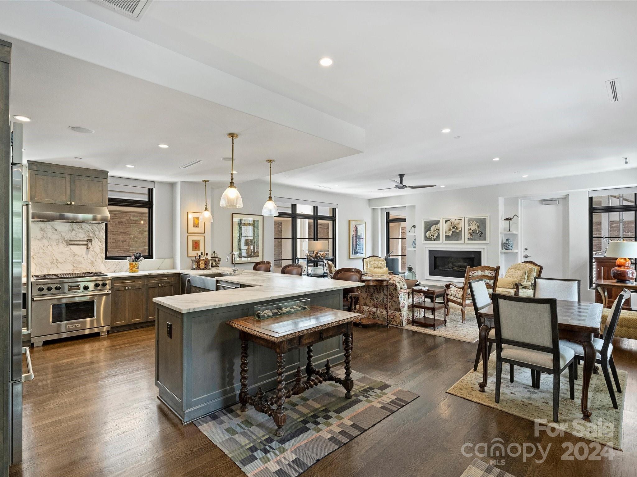 1333 Queens Road, Unit E3 Charlotte, NC 28207 - Photo 8 of 42 a large kitchen with a table and chairs in it