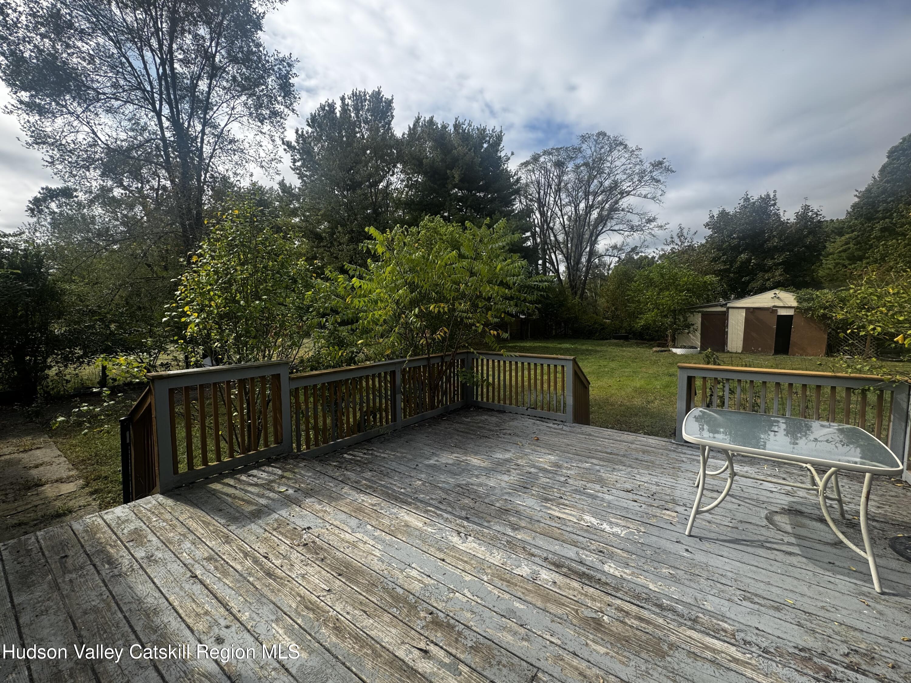 14 Snyder Circle Stone Ridge, NY 12484 - Photo 15 of 19 a balcony with table and chairs a barbeque with wooden floor and fence
