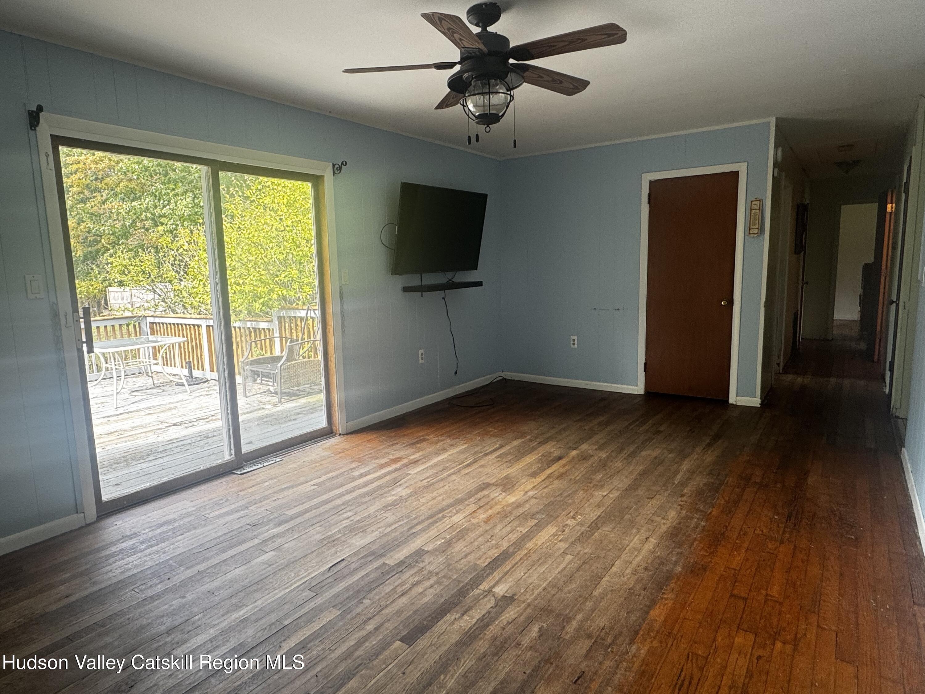 14 Snyder Circle Stone Ridge, NY 12484 - Photo 4 of 19 a view of empty room with wooden floor and fan