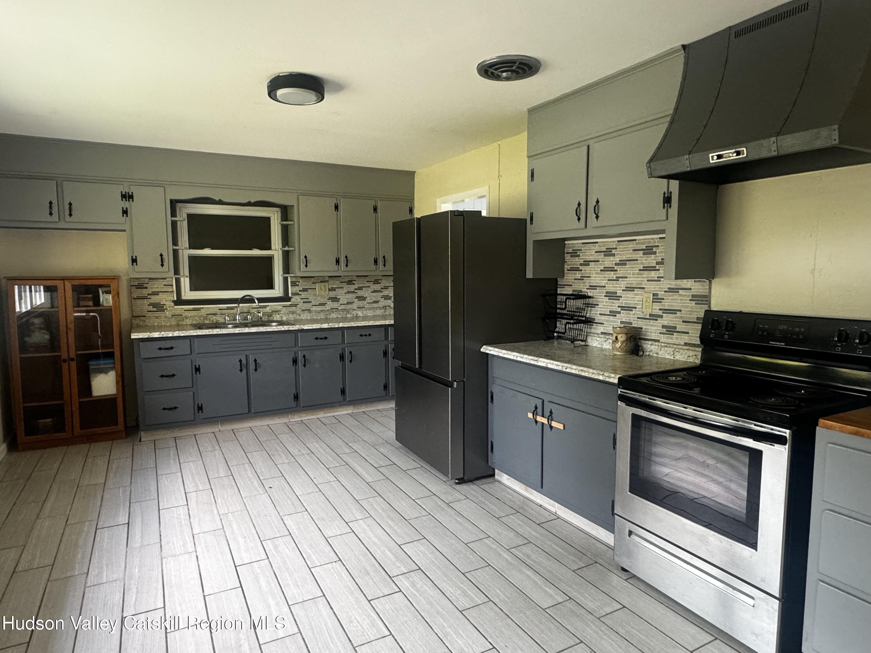 14 Snyder Circle Stone Ridge, NY 12484 - Photo 5 of 19 a kitchen with stainless steel appliances granite countertop a stove and a refrigerator