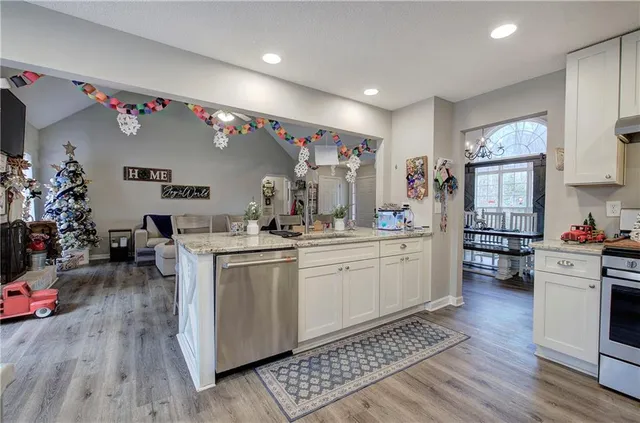 a kitchen with sink cabinets and wooden floor