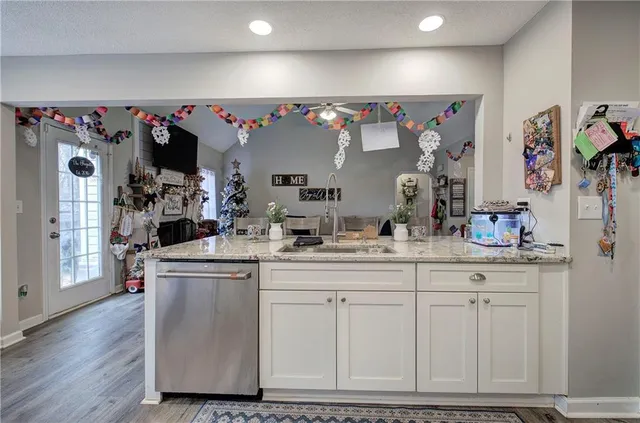 a kitchen with stainless steel appliances granite countertop a refrigerator and a stove