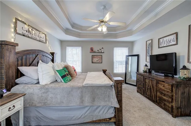 a bedroom with a bed and a chandelier